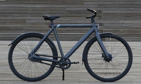 The VanMoof S3 ebike standing against some stairs.