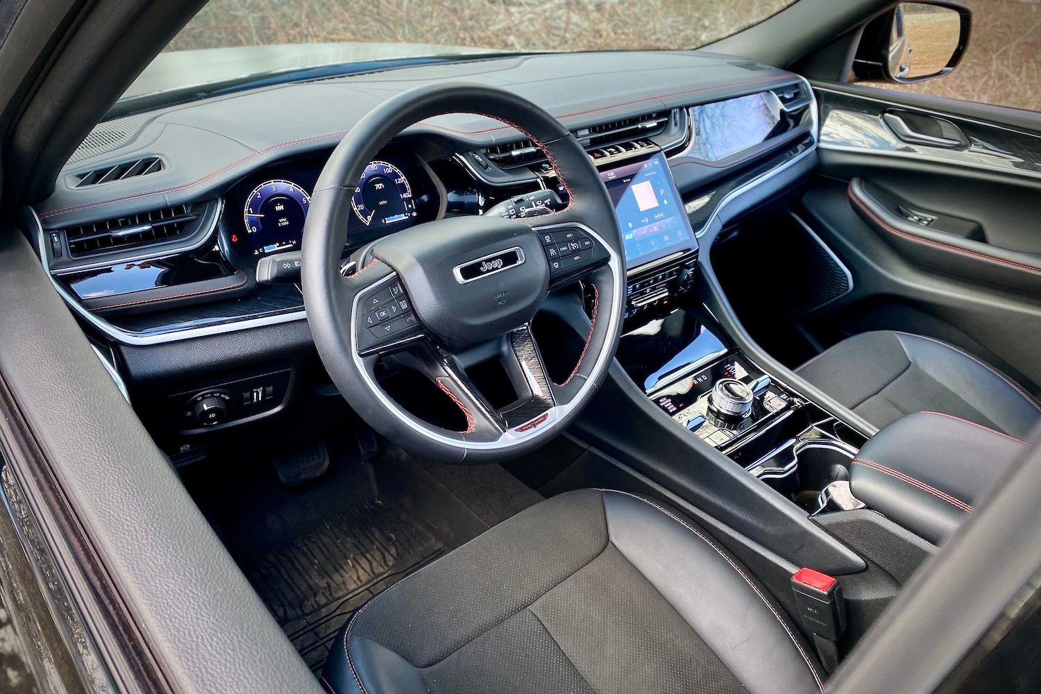 2022 Jeep Grand Cherokee Trailhawk Close up of steering and dashboard from outside SUV.
