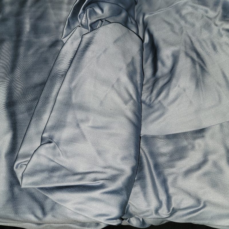 A set of slate blue Clean Design Home x Martex bed sheets on my bed.
