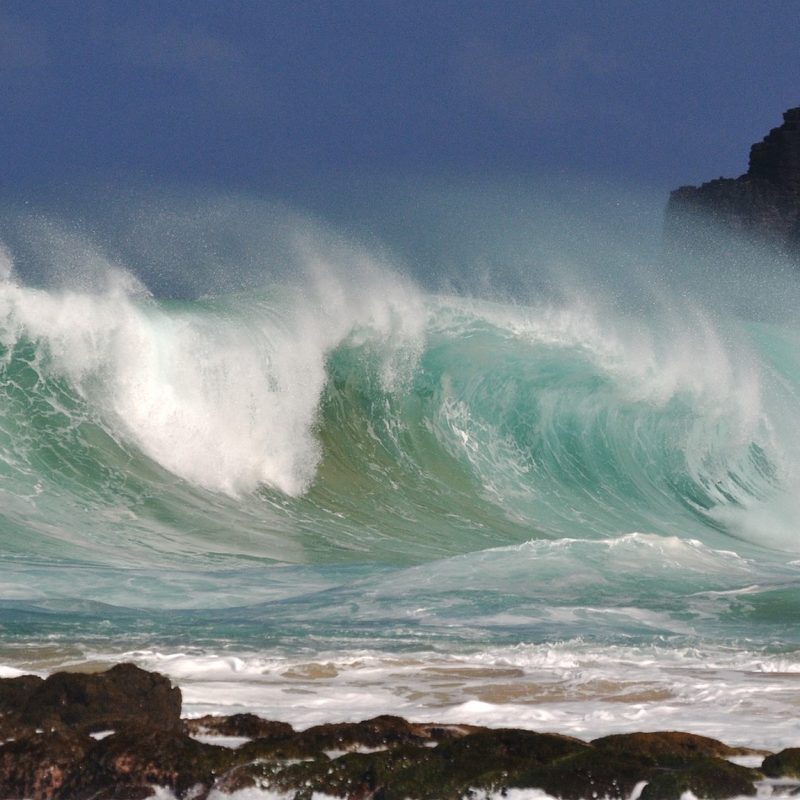 A big wave crashes ashore at Kauapea Beach, Kauai, Hawaii.