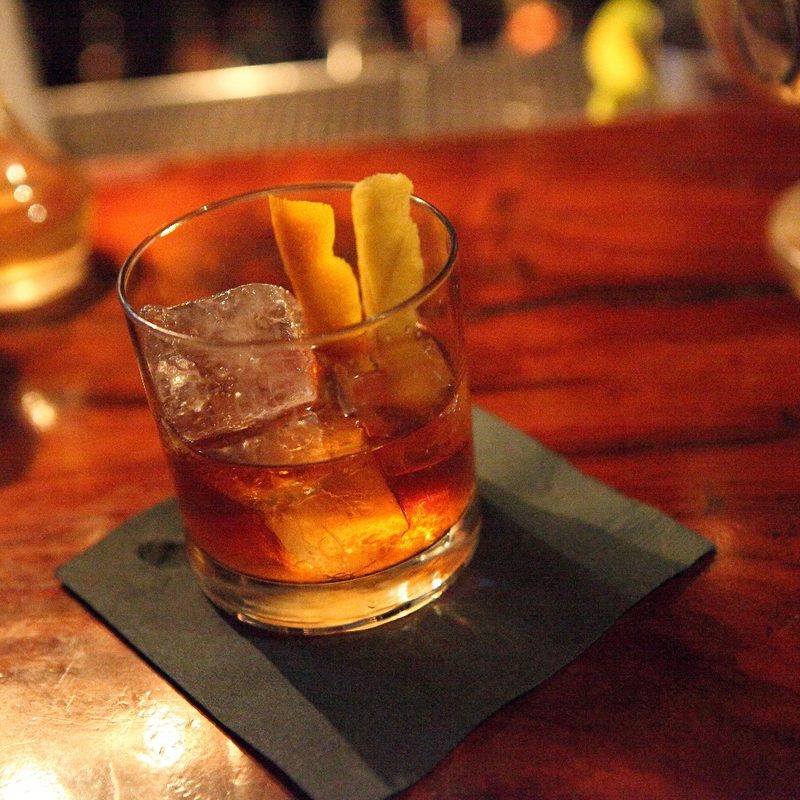 An Old Fashioned whiskey cocktail at a bar.