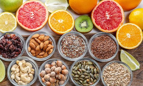 An assortment of citrus fruits and nuts.