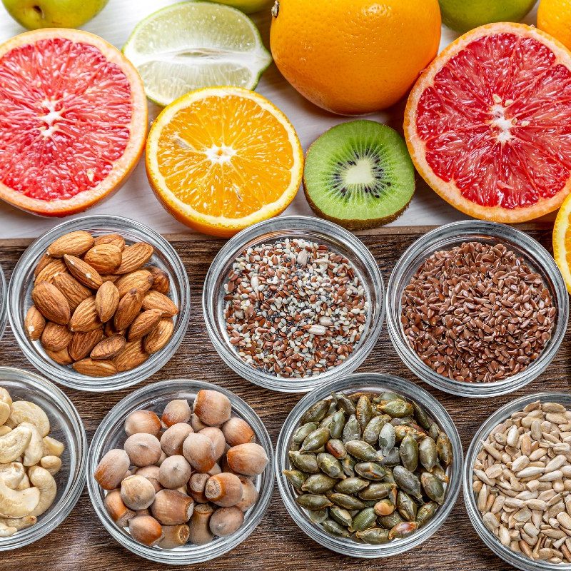 An assortment of citrus fruits and nuts.