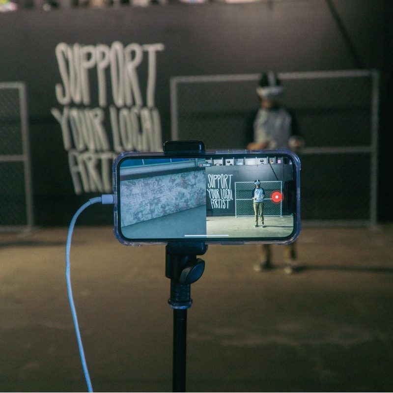 A phone filming Nina Palomba as she works on her virtual reality Secret Wall during her 'battle' with Gabe Gault.