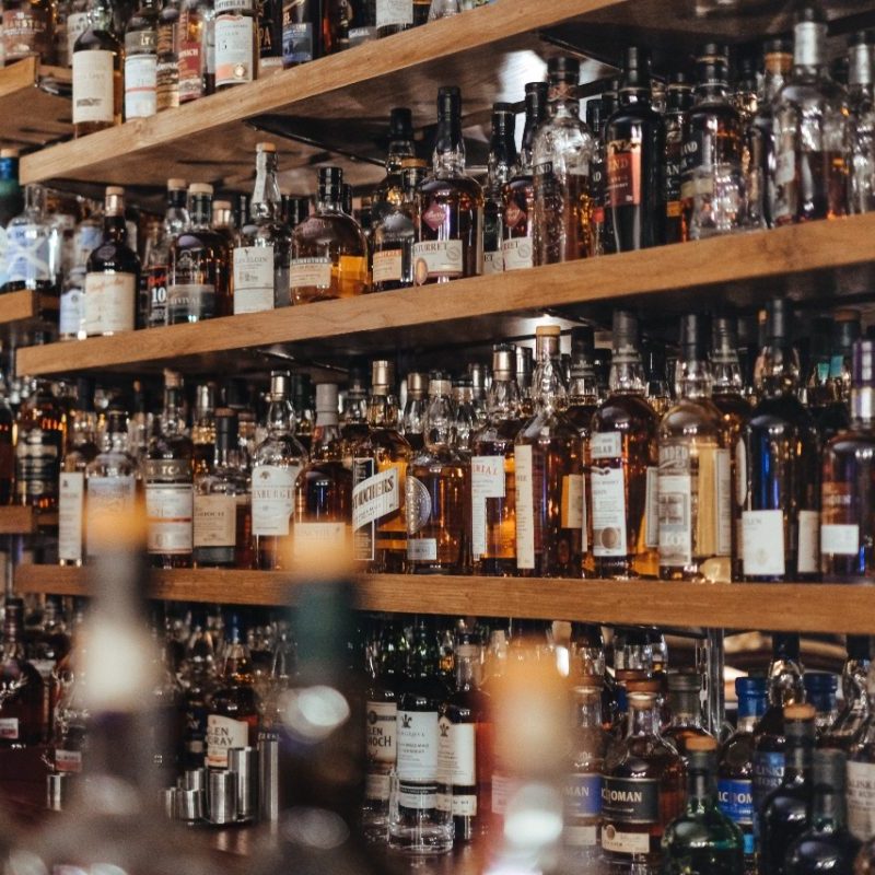 An assortment of liquor bottles on shelves