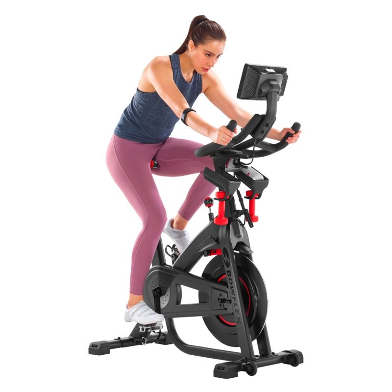A woman rides a Bowflex C7 exercise bike.