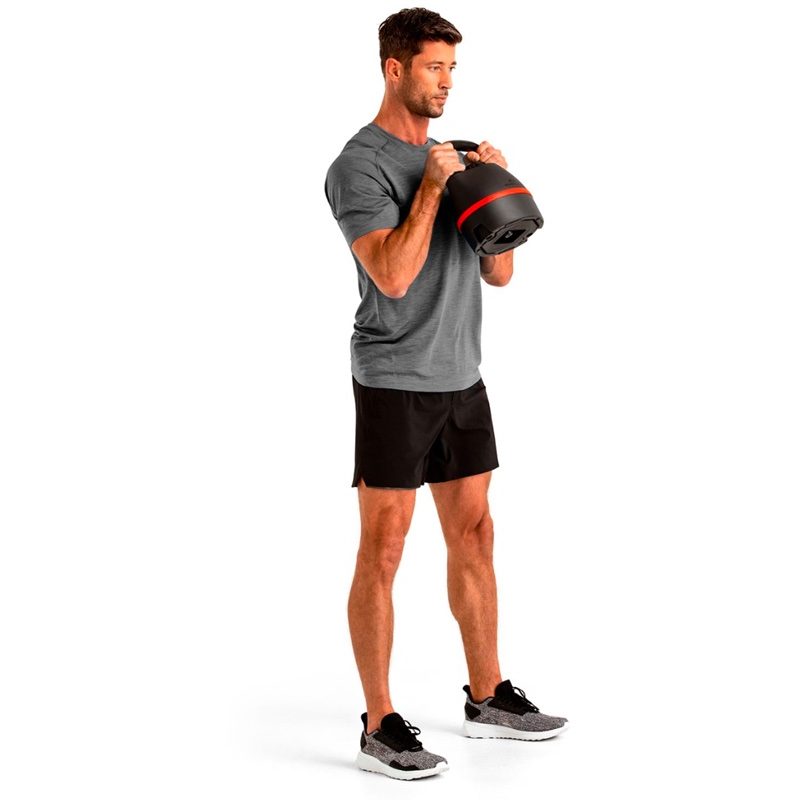 A man does kettlebell exercises.