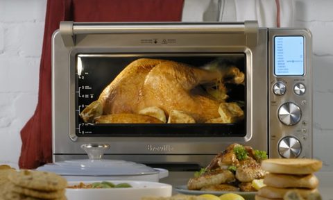 A Breville smart oven air fryer cooking a whole chicken.