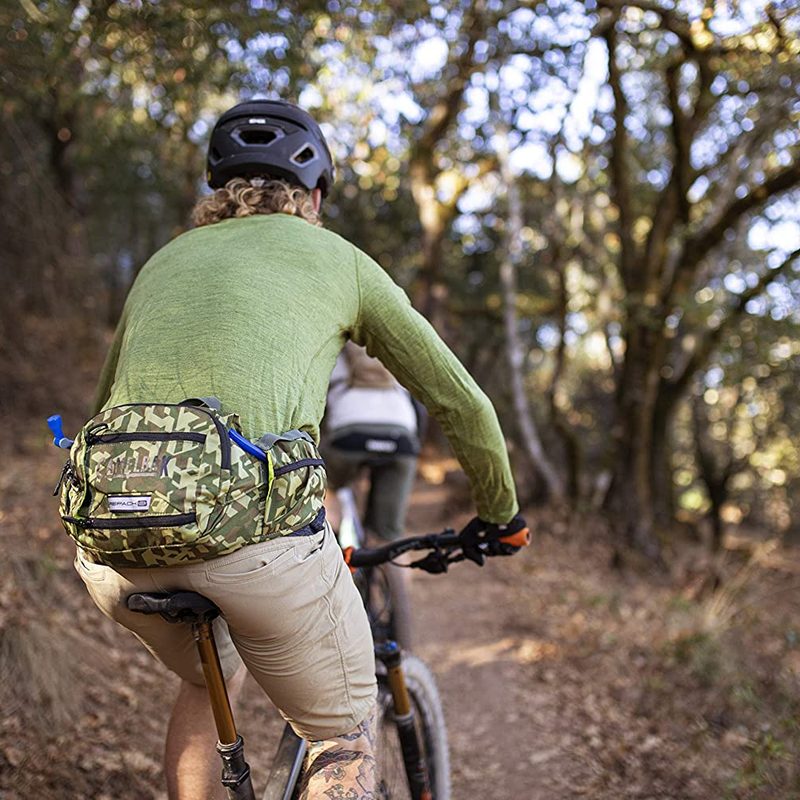 Mountain biker using the Camelbak Repack LR4 hip pack in camo..