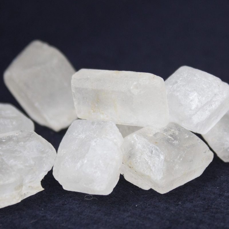 Crystalized sugar against a dark background.