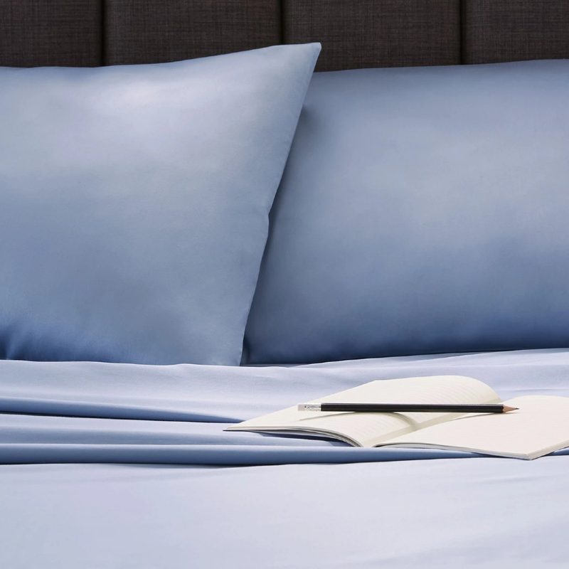 A set of slate blue Clean Design Home x Martex bed sheets.