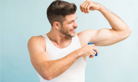 Man applying deodorant.