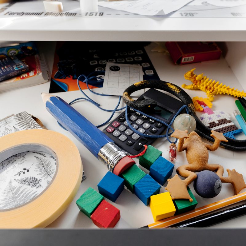 Drawer with things in boy's desk.