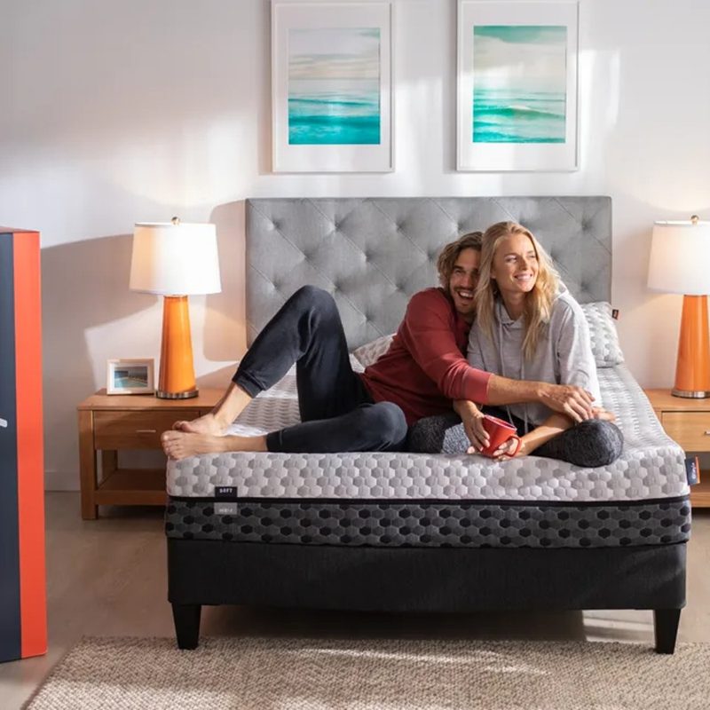 A couple lie on the Layla Memory Foam Mattress in the bedroom.