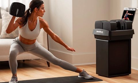 A woman works out with the NordicTrack iSelect adjustable dumbbells.