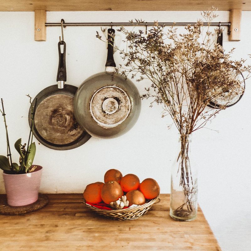 Pans hanging near a wall in a kitchen. 