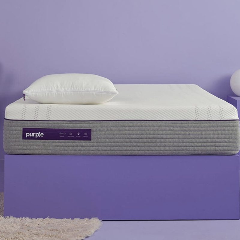 The Purple Hybrid Mattress in a purple bedroom.