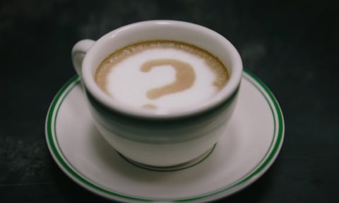 The Riddler's signature question mark drawn into a cup of coffee in 'The Batman' film.