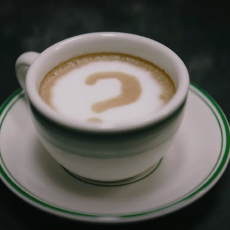 The Riddler's signature question mark drawn into a cup of coffee in 'The Batman' film.