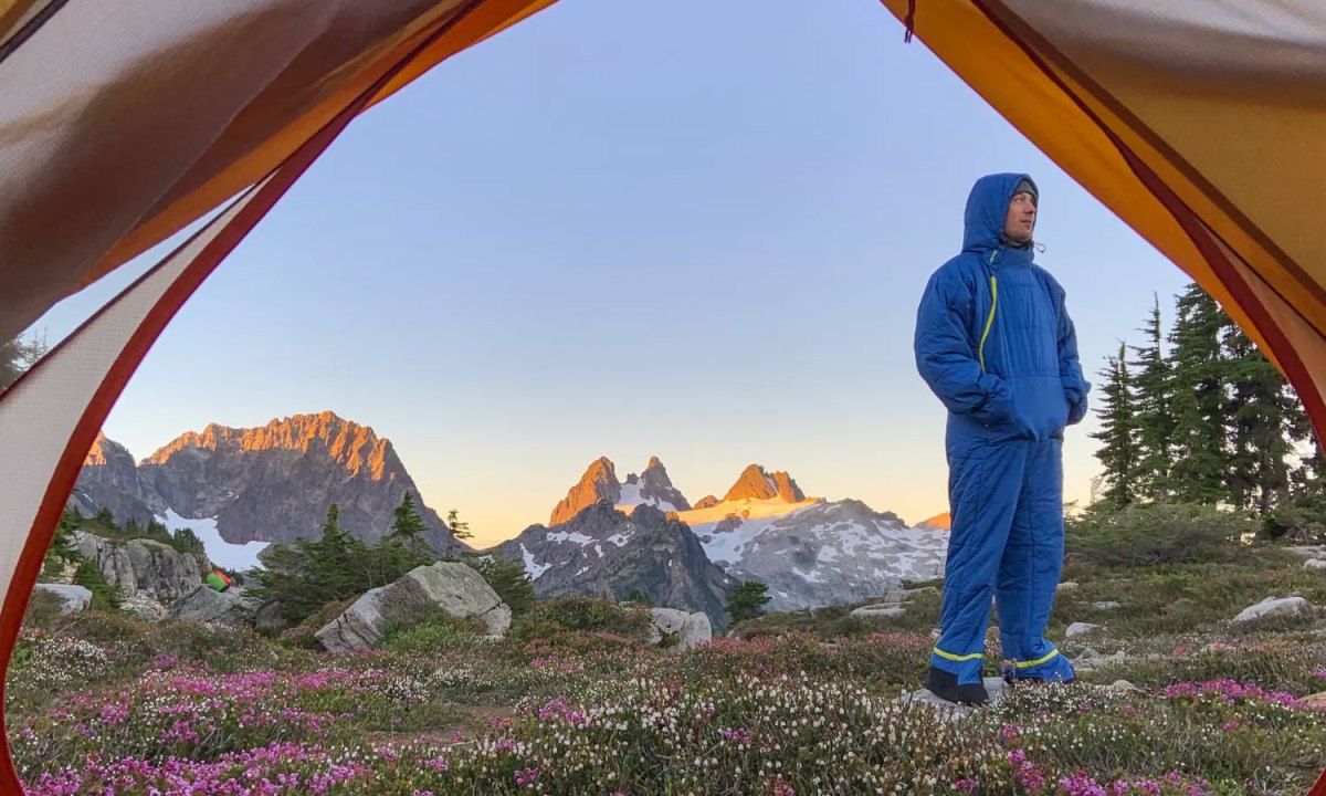 Man wearing a Selk'bag Nomad Wearable Sleeping Bag in the mountains.
