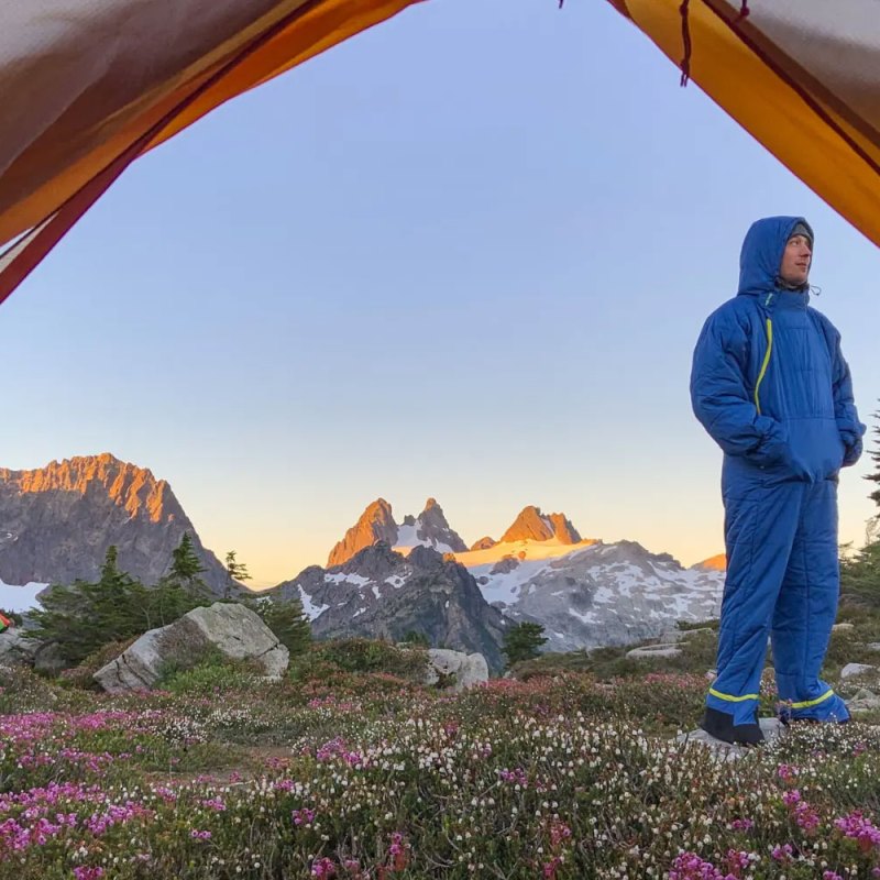 Man wearing a Selk'bag Nomad Wearable Sleeping Bag in the mountains.