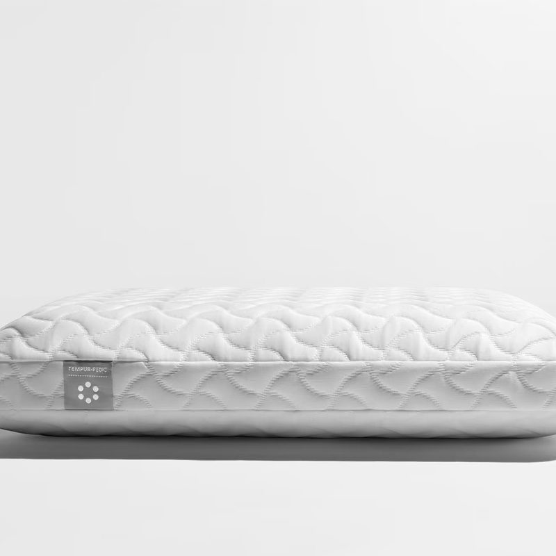 The Tempur-Cloud pillow sits on a white table.