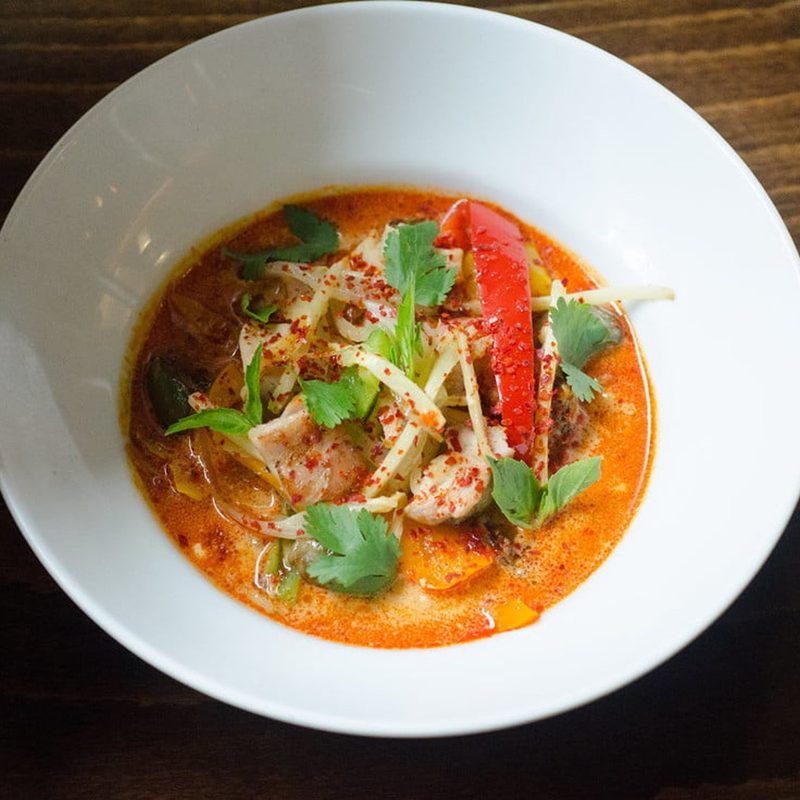 bowl of red curry with chicken.