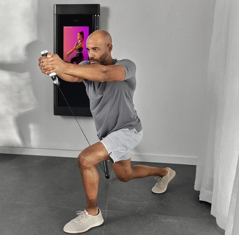 Tonal smart home gym and pulleys in use.