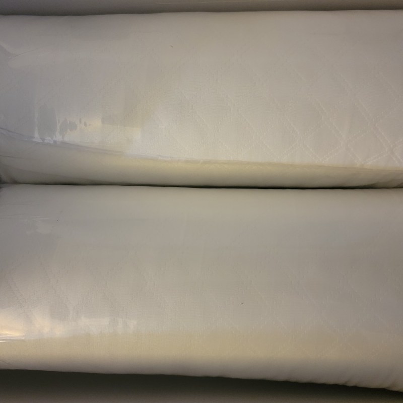 The Nolah Squishy Pillows compressed in their original packaging.