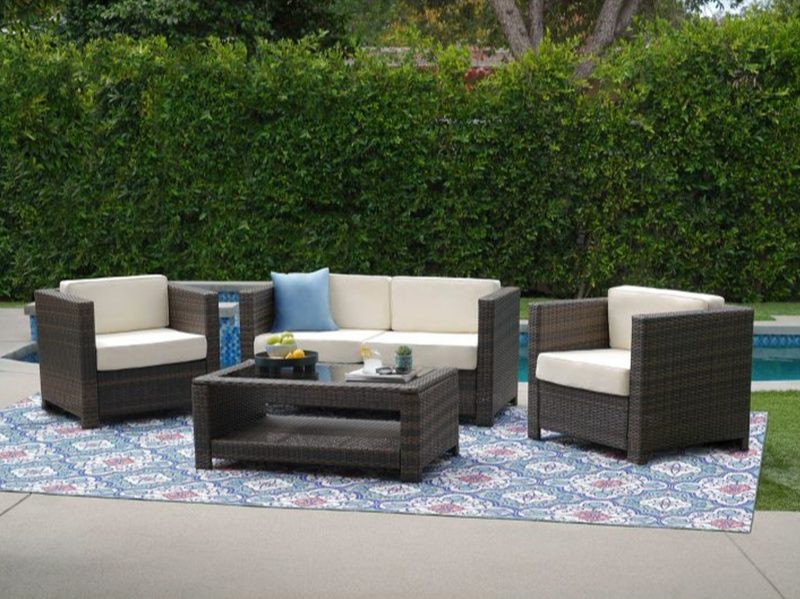 Brenda 4-piece outdoor wicker patio set in brown by Abbyson Living at poolside.