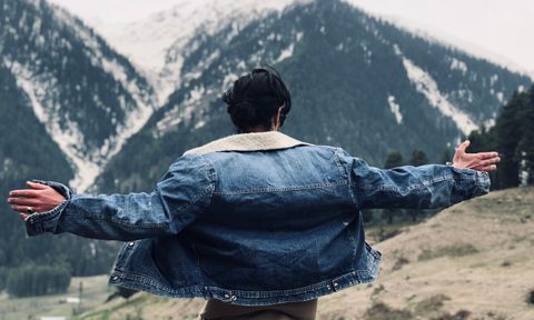 Person in a denim jacket outside