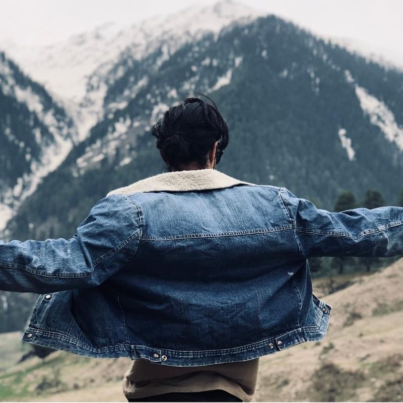 Person in a denim jacket outside