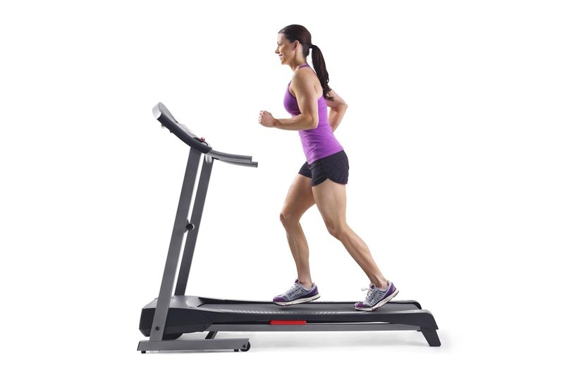 A woman runs on the Weslo Cadence G 5.9i folding treadmill.