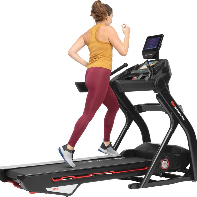 A woman runs on a Bowflex Treadmill 10.