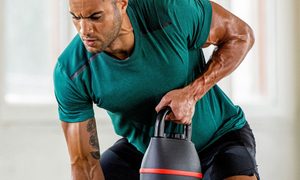 A man works out with a Bowflex SelectTech 840 Adjustable Kettlebell.