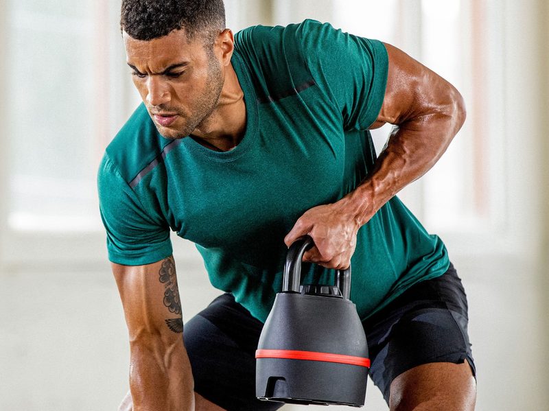 A man works out with a Bowflex SelectTech 840 Adjustable Kettlebell.