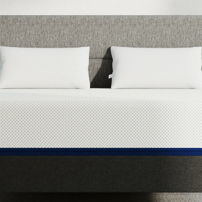amerisleep as5 mattress on a bedframe with two pillows.