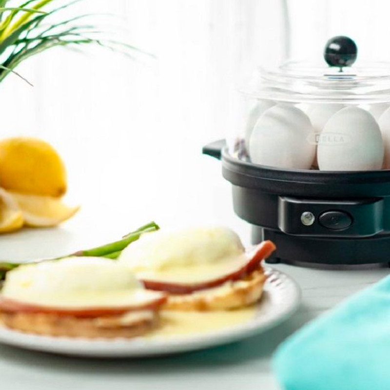 The Bella egg cooker with a plate of eggs benedict.