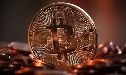 A physical, gold-colored Bitcoin.