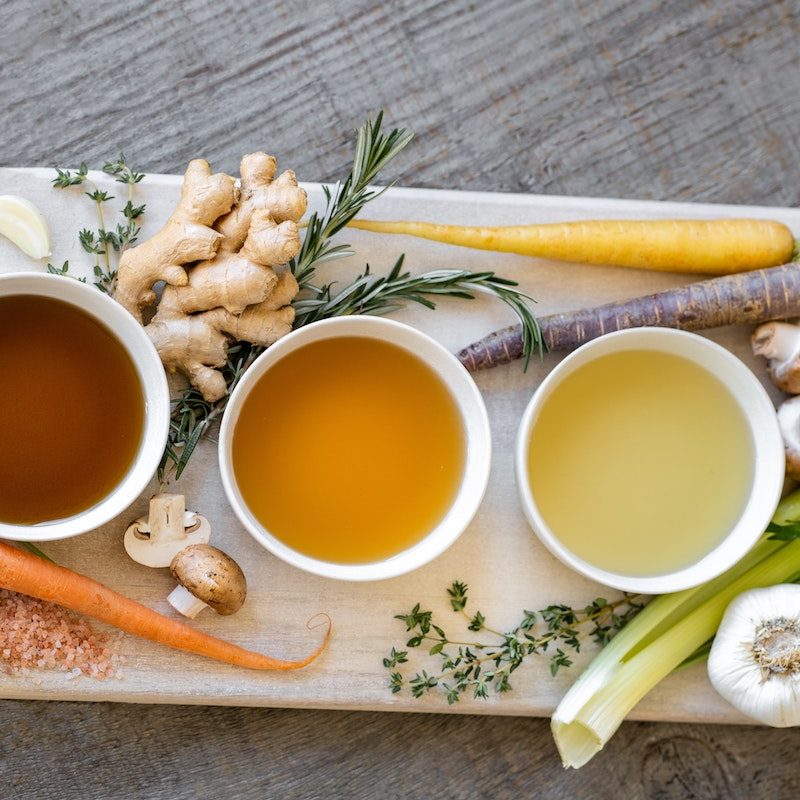 Bowls of bone broth on a tray