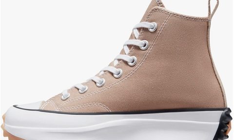 Tan platform Chuck Taylor hiking shoes on a a white background.