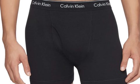 model wearing Calvin Klein boxer briefs on a white background