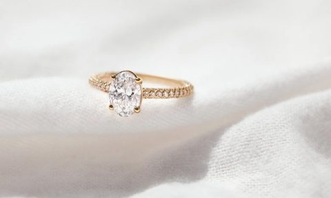 A gold engagement ring set with a Clean Origin lab-grown diamond.