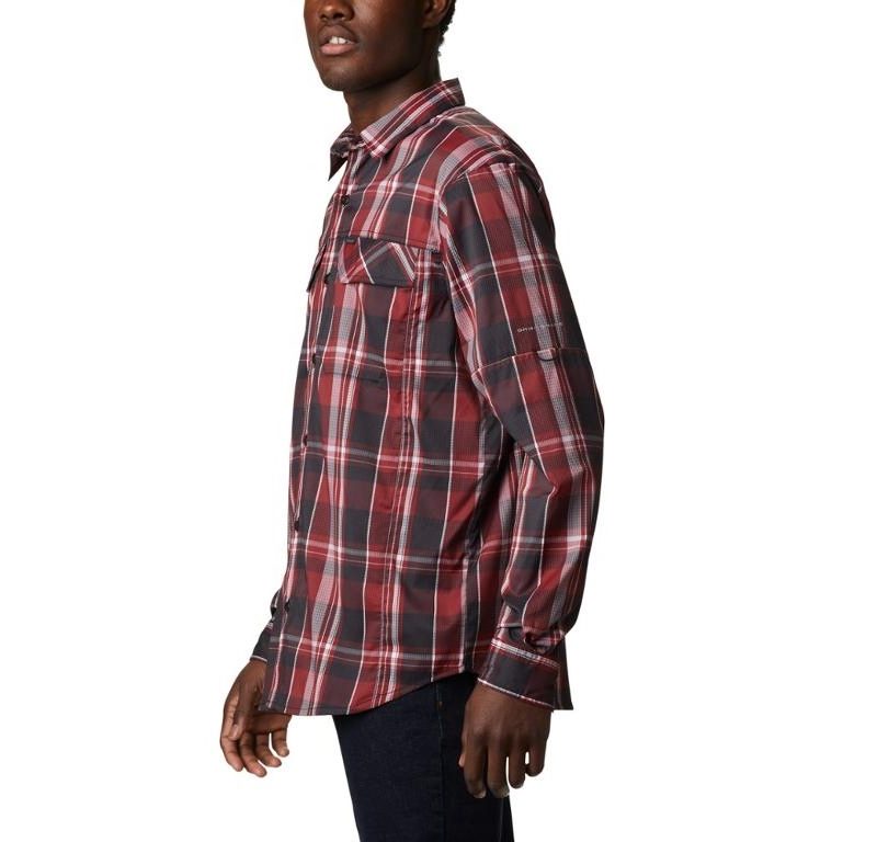 A man wearing a red, white and black flannel shirt.