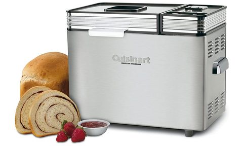 The Cusinart CBK-200 convection bread maker is sits next to a loaf of bread and strawberries.