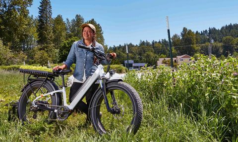 E-bike rider in a grassy field with flowers with a Rad Rover 6.