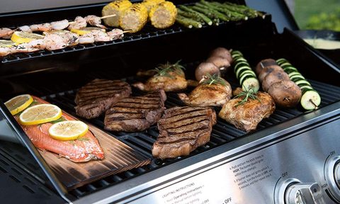 Expert Grill 5-burner gas grill cooking meats and side dishes.