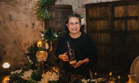 Zacapa rum's master blender, Lorena Vásquez holding a rum bottle.