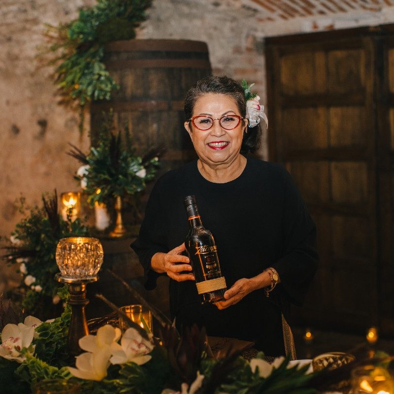 Zacapa rum's master blender, Lorena Vásquez holding a rum bottle.