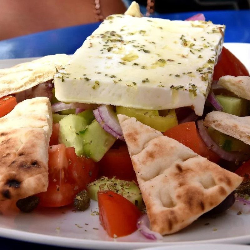 A Greek salad seasoned with Greek table seasoning.